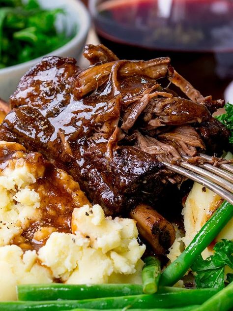 Slow Cooker beef short ribs. Fall-apart beef served with a rich and red wine gravy. This is serious comfort food. #shortribs #beefshortribs #comfortfood #dinnertonight #winterfood #SlowCooker #slowcooked #Beef #Crockpot #Recipe #glutenfree #glutenfreedinner Beef Ribs Slow Cooker, Short Rib Recipes Crockpot, Short Ribs Crock Pot, Slow Cooker Beef Short Ribs, Boneless Beef Ribs, Meals Crockpot, Wine Gravy, Boneless Short Ribs, Boneless Beef Short Ribs