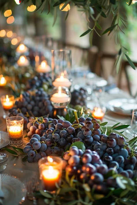 ✨ Elevate your wedding ambiance with a centerpiece that whisks you away to the rolling hills of Tuscany. Experience the charm of Italy as grape vines & olive branches intertwine with the warm glow of candles on your special day. #WeddingInspiration #TuscanWedding #RomanticDecor #WeddingIdeas #CountryChic #RusticElegance #GrapeAndOlive #CandlelightMagic Let the light guide your love story. Vine Table Decor, Italian Inspired Centerpieces, Wine Cork Table Decor, Grape Centerpiece Wedding, Wine Dinner Centerpieces, Grapes Centerpiece Wedding, Grape Wedding Decor, Italian Centerpieces Table Decorations Tuscan Style, Grape Centerpiece Ideas