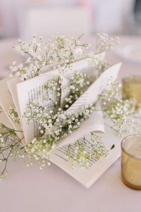 Use books for centerpieces for a unique personal touch at your reception! | Photography by Emma Farr Photography Book Decor For Wedding, Book Bridal Shower Theme Centerpieces, Unique Graduation Centerpieces, Book Themed Wedding Centerpieces, Baby Shower Book Centerpieces, Book Themed Wedding Shower Ideas, Book Lover Wedding Ideas, Book Centerpiece Ideas, Book Themed Bridal Shower Ideas