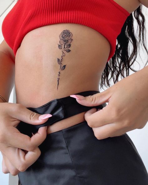 Psalm 46:5 on ribs. Detailed rose tattoo. Rose Ribcage Tattoos For Women, Rose Tattoos Ribs, Rose Side Rib Tattoo, Cute Tattoos On Ribs, Rose With Bible Verse Tattoo, Rose Cursive Tattoo, Rose Bible Verse Tattoo, Name In A Rose Tattoo, Bible Verse Tattoos On Ribs