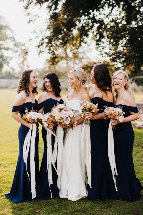 Smiling bride and bridesmaids at Elmore cost wedding in navy blue bridesmaid dresses Deep Navy Bridesmaid Dresses, Navy Blue And Rose Gold Wedding Bridesmaid Dresses Bridal Parties, Black Tie Wedding Blue Bridesmaids, Storm Blue Wedding, Bridesmaids Navy Blue, Bridesmaid Ideas Dresses, Nautical Bridesmaid Dress, Dark Blue Bridesmaids, Bridesmaid Dresses Country