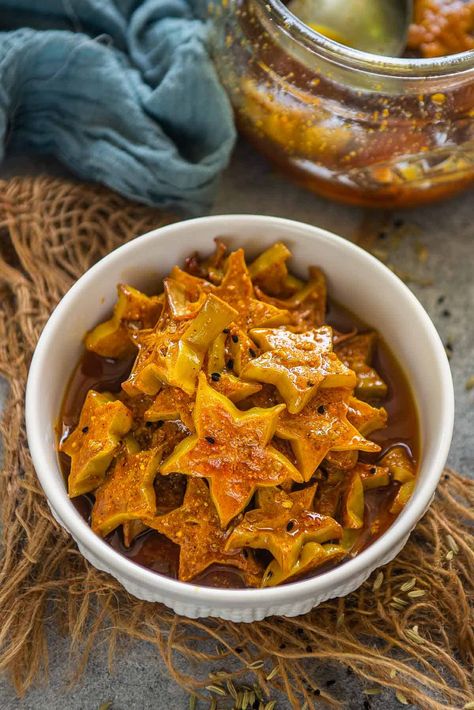 Starfruit Pickle (Kamrak Ka Achar) is a different and unique Indian pickle recipe that you need to try this summer! It is just like your green mango pickle but with the goodness of starfruit. It is easy, addictive, and requires a few basic pantry ingredients (vegan, can be easily made gluten-free). Green Mango Pickle, Star Fruit Recipes, Indian Pickle Recipe, Green Chilli Pickle, Mango Pickle, Green Mango, Star Fruit, Pickle Recipe, Pickling Spice