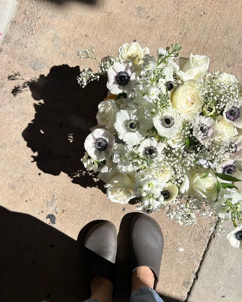 These black and white anemones stood out beautifully nestled next to white roses and baby's breath. The perfect flower for a black and white wedding. White Anemones, Anemone Wedding, Black Tablecloth, White Anemone, Wedding Tablescape, Oklahoma Wedding, Baby Breath, Baby S Breath, Anemone Flower