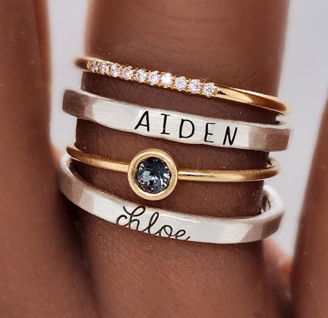 The Athena Ring Set offers a timeless combination of classic elegance and fine craftsmanship. Crafted from pure silver and 14K yellow gold filled, the set includes a 4mm gray cz stone and a custom-made name ring in both uppercase skinny font and lowercase cursive. It also includes our new cz stone ring with 10 tiny sparkles. Get a timeless look with this exquisite and beautiful set. We highly recommend ordering our ring sizer before purchase to ensure a good fit. Some people need to size up half Rings Mixed Metals, Names Jewelry, Stackable Name Rings, Birthstone Stacking Rings, Mothers Ring, Push Presents, Mixed Metal Rings, Handwriting Jewelry, Jewelry Aesthetic