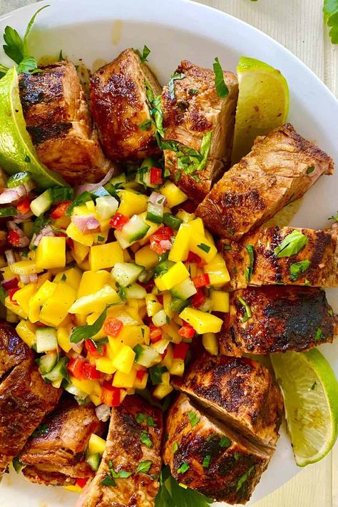 This 30 minute pork tenderloin with mango salsa recipe is an explosion of savory, sweet, salty, and spicy flavors. Perfectly roasted and juicy pork tenderloin pairs deliciously with tropical sweet mango salsa with a kick of heat from jalapenos. This is an easy and amazing dinner for any night of the week. Mango Marinade For Pork, Spring Pork Tenderloin, Pork Tacos With Mango Salsa, Mango Pork Tenderloin, Summer Pork Tenderloin Recipes, Pork And Pineapple Recipes, Mexican Pork Tenderloin Recipes, Summer Pork Recipes, Pork With Mango Salsa