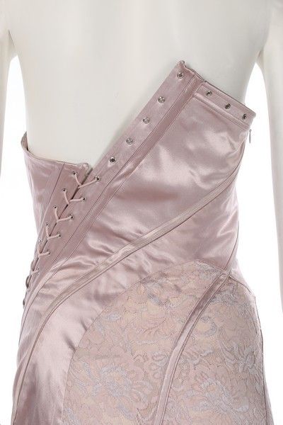 A John Galliano pink satin and lace gown, Spring-Summer 2000, labelled and UK size 12, the asymmetric corset-like bodice with diagonal lacing which continues down through the fish-tail skirt, bust 92cm, 36in, waist 66cm, 26in    This was look no. 12 on the catwalk. Bella Hadid wore an identical gown to the Bulgari perfume launch in Rome, 24th May 2017. John Galliano Corset, Corset Runway, Bulgari Perfume, Asymmetrical Corset, Corsets Fashion, Corset Lacing, Corset Skirt, Collection Couture, Dressy Casual Outfits