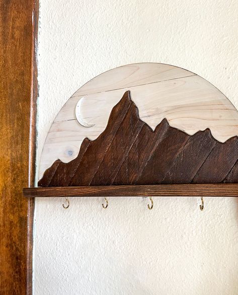 Elevate your entryway with The Ridge Keyhook Shelf! Featuring reclaimed lath wood from a 100 year old farmhouse, this sleek and one of a kind shelf showcases a beautiful mountain ridge design. The half round shape is both functional and stylish with 4 hooks for your keys and other essentials. (Pictured in half the photos.) Sealed with lacquer for long-lasting durability. This shelf can be created with or without a crescent moon. This shelf can also be created as a propagation station with four glass tubes. Leave a note at checkout specifying whether you’d like a moon and whether you’d like this shelf as a propagation station. If no note is included, I’ll create it without the moon and as a keyhook shelf with 4 hooks for hanging keys or jewelry. Add a touch of natural charm and organization 100 Year Old Farmhouse, Mountain Shelf, Propagation Station, Wood Artwork, Old Farmhouse, Hanging Hooks, Beautiful Mountains, Boys Room, Handmade Wood