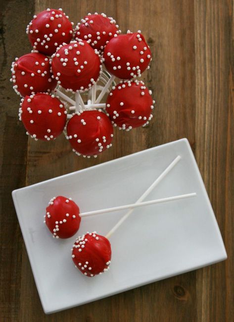 Cake pops are a delicious treat. They make great gifts, table toppers, stocking stuffers, or party favors. By changing the color and adding a few pearl sprinkles, cake pops are the perfect way to add a special touch to any get together. Visit www.makingmotherhoodmatter.com or click the link to exactly how to make my red velvet cake pop recipe, without having to buy any fancy gadgets. Red Party Snacks, Red Snacks For Party, Red Snacks For Color Party, Red Velvet Cake Pops Recipe, Red Treats, Red Cake Pops, Babycakes Cake Pop Maker, Red Velvet Cake Pops, Cake Pops Recipe