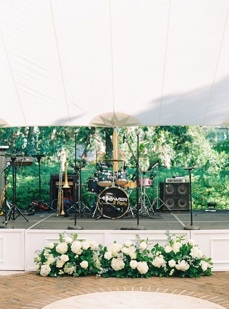 White stage wedding band set up with flowers. Power 2 Party wedding band. Charleston wedding photographer. Live Band Wedding Stage, Flowers In Front Of Band Wedding, Wedding Live Band Set Up, Wedding Band Stage Flowers, Stage Flowers Wedding, Tent Wedding Florals, Wedding Stage Flowers, Wedding Band Stage Decor, Band Stage Wedding