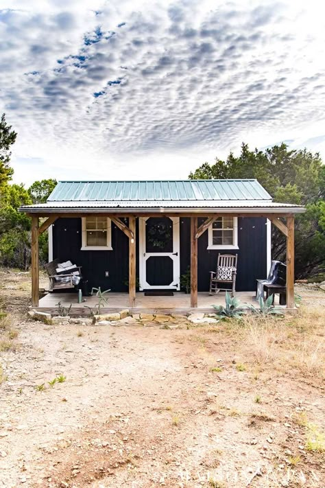 Shed House With Porch, Black Shed With Wood Trim, Tiny Cabin With Porch, Black Shed White Trim, Christmas Farmhouse Porch, Tiny House Porch, Simple House Exterior, Pavilion Ideas, Tiny Farmhouse