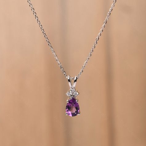 It is a natural amethyst pendant, pear cut, measures 9x6 mm,about 1.34 carats The basic metal is sterling silver and plated with rhodium. To change the metal to a solid gold (white/rose) or platinum is also available, please ask for a quotation if you want. You can also go to my shop Home for more elegant rings:  https://www.etsy.com/shop/godjewelry?ref=hdr_shop_menu Amethyst is birthstone of February More alexandrite rings: https://www.etsy.com/shop/godjewelry?ref=seller-platform-mcnav&section_ Silver Chain And Pendant, Elegant Pendant Earrings, Silver Chains With Pendant, Silver Pendant Necklace Unique, Platinum Jewelry Necklaces, Amethyst Accessories, Necklaces Amethyst, Amethyst Jewelry Necklace, Amethyst Necklaces