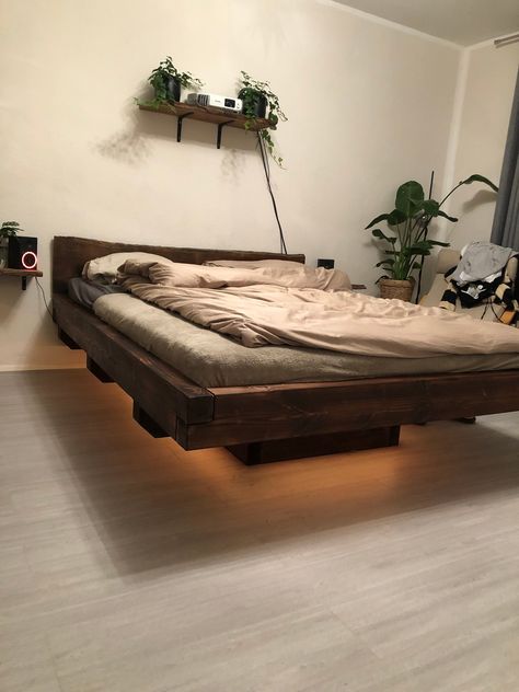 self-made floating bed made of flamed larch wood. Headboard is an oak plank. There are LED strips under the bed Bed Without Frame On Floor Metal, Floating Bed Frame Lowe's, No Headboard Loft, Pallet Board Headboard With Lights, Hallway Beds For Adults, Unique Bed Options, His Hers Bed Frame, Unique Bed Frame For Boys, Unusual Wooden Beds