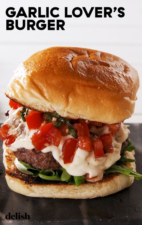 This burger was MADE for garlic lovers. Get the recipe at Delish.com. #recipe #easy #easyrecipes #delish #garlic #burger #hamburger #tomatoes #groundbeef #beef #sandwich #basil #cheese #mozzarella #parmesan Garlic Burgers Recipe, Ground Beef Burger Recipes, Garlic Burger Recipe, Beef Burger Recipes, Garlic Burgers, Burger Specials, Weeknight Dinner Recipes, Cheese Mozzarella, Best Burger Recipe