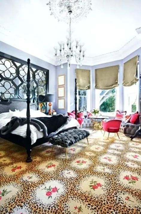 Picture of a gorgeous maximalist bedroom with lilac walls, a black bed and an ottoman, red chairs and a grey windowsill bench, a crystal chandelier Maximalist Bedrooms, Lilac Walls, Bright Bedding, Bold Bedding, Green Bedroom Walls, Maximalist Bedroom, White Wash Walls, Eclectic Decor Bedroom, Dark Accent Walls