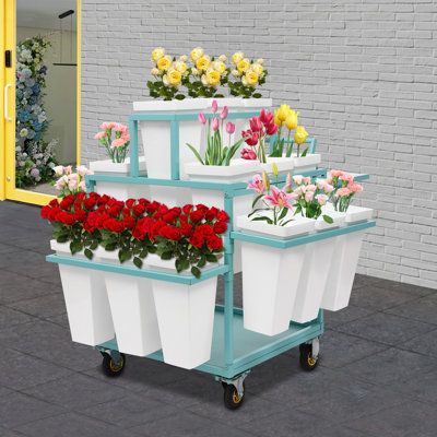 This flower display stand is not only a stage for flowers but also a spiritual poem in your home life. It is carefully crafted with high-quality materials and blends modern design aesthetics with practicality, allowing the storey of each bouquet to be interpreted. Its multi-layer design is staggered, so that even a small space can create a rich visual hierarchy, allowing each flower to have its stage. Choose it to add a splash of colour to your life. | Arlmont & Co. Rolling Flower Display Rack S Flower Display Stand, Spiritual Poems, Plant Rack, Telephone Table, Visual Hierarchy, Life Color, Design Aesthetics, Flower Display, Display Rack