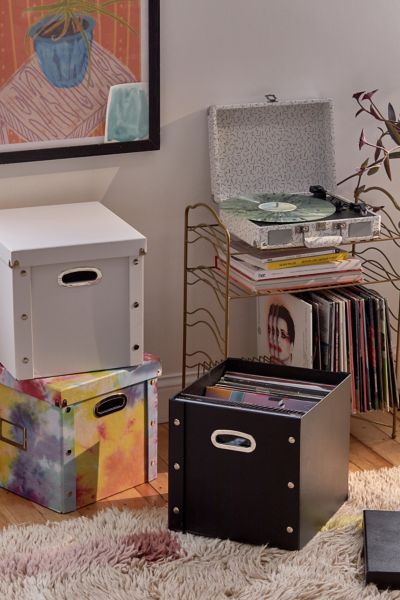 A classic for storing and toting your record collection, this lidded storage box features space for a label and cutout handles along the sides. Stores up to 75 records.Content + Care. PVC Wipe clean Imported Size. Dimensions: 12.5”l x 13.38”w x 12.63”h Weight: 3 lbs Shipping package dimensions: 13.5”l x 1.75”w x 15”h Shipping package weight: 3.2 lbs Alternative Room, Bedroom Storage Boxes, College Storage, Room Redecorating, Three Amigos, Metal Bookshelf, Pinterest Contest, Dorm Ideas, Lid Storage