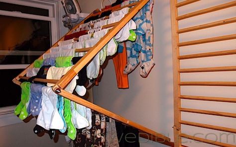 I repurposed a wooden baby safety gate system I got off Freecycle and a few pot-hooks into a wall-mounted clothes drying rack. The rack folds out to provide lots of room and airflow for delicates and other items I prefer to air dry, and folds flat against the wall when not in use to save space. After building this rack, I am certain that with a little creativity, many crib panels, baby safety gates and other slatted panels can be repurposed into clothes drying racks. The best part? The… Diy Clothes Drying Rack, Wall Mounted Clothes Drying Rack, Clothes Dryer Rack, Diy Baby Gate, Old Cribs, Wall Mounted Drying Rack, Baby Clothes Storage, Laundry Rack, Drying Rack Laundry