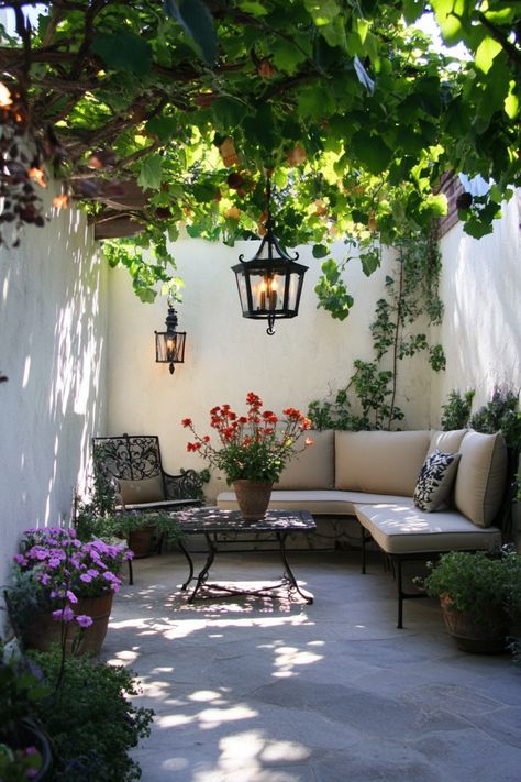 Outdoor patio with a cozy seating area, lush plants, and hanging lanterns. Diy Backyard Christmas Decor Ideas, Simple Diy Backyard Ideas, Outside Spaces Ideas Backyards, Simple Outdoor Seating Area, Balcony Outdoor Ideas, Front Patio Ideas Small, Small Back Yard Ideas On A Budget Easy Diy Projects, Diy Small Backyard Ideas On A Budget, European Outdoor Patio