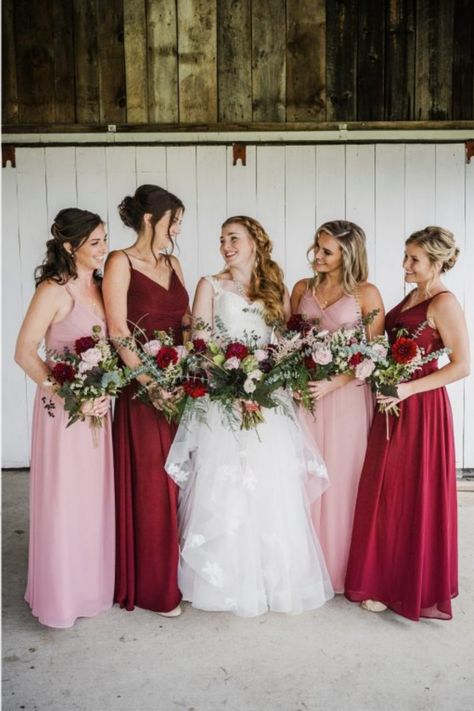 Bridesmaids wearing red and pink dresses in a rustic fall wedding. Red And Pink Rustic Wedding, Pink Red And White Wedding Bridesmaid Dresses, Magenta Pink Wedding Theme, Red And Pink Wedding Bridesmaid Dresses, Pink Red Burgundy Wedding, Red And Blush Bridesmaid Dresses, Deep Red And Pink Wedding, Red And Pink Wedding Party, Light Pink And Maroon Wedding