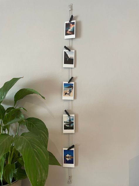 Vertical Cable Photo Display // Wire Photo Hanger // Polaroid Prints // Multiple Picture Display Standard length is 85cm but if you want a custom length then please order and add you desired length in the personalised message option. Vertical photo display with 5 black wooden pegs to hold photos/ Instax mini polaroids or mementos, A beautiful gift for yourself or a loved one. Everything required for quick and easy fitting. The discreet clear mounts blend in with your decor, and remove without da Polaroid Wall Art, Polaroid Pictures Display, Polaroid Wall Decor, Hanging Multiple Pictures, Wire Photo Holder, Polaroid Display, Polaroid Wall, Photo To Art, Framed Photo Collage