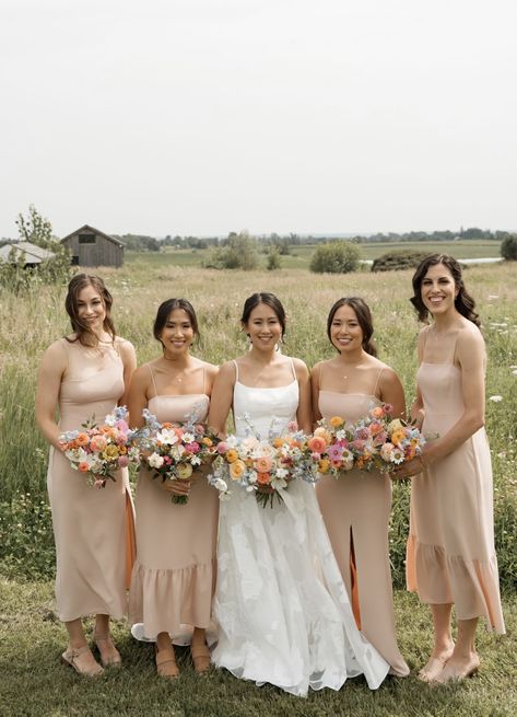 Champagne Bridesmaid Dresses With Pink Flowers, Colorful Bouquets Wedding, Champagne Bridesmaid Dresses With Bright Florals, Pastel Wedding Theme Bridesmaid Dress, Wildflower Bridesmaid Bouquet, Neutral Bridesmaid Dresses Mismatched, Bouquet Styles, 2026 Wedding, Pastel Wedding Theme