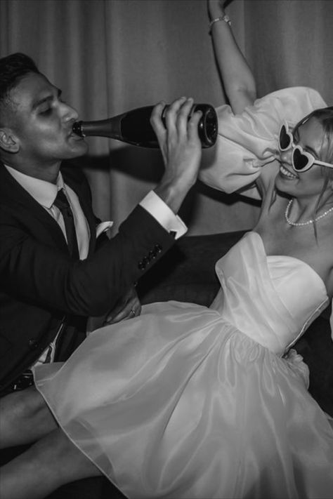 Bride in puff sleeve short wedding reception dress with retro wedding sunglasses celebrating with the groom drinking champagne from the bottle | wedding day | disco wedding | retro sunglasses | short wedding dress | reception wedding dress | wedding drinks | Lindsey Ria Photography Retro Bride Photoshoot, Short Wedding Dress Sunglasses, Short Wedding Dress Photoshoot, Bride And Groom Sunglasses, After Party Photoshoot, Bride Sunglasses Wedding, Retro Wedding Photoshoot, Retro Wedding Reception, Short Wedding Reception Dress