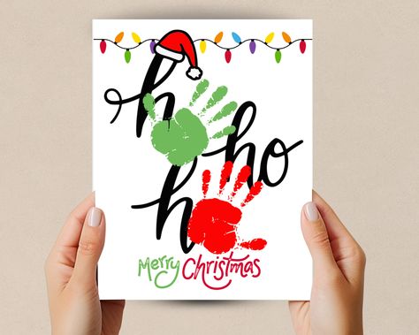 Celebrate this Christmas season with this Handprint craft Christmas printable. This handprint art is designed to bring creativity to your home, classroom, or craft time. This Ho Ho Ho Handprint Art is a great Christmas Decoration or gift. Whether you're a parent or teacher these charming handprint designs will make your Holiday decorations special and personalized. Great toddler handprint activity and homeschool craft.  What's Included:  High-Resolution PDF Files: File is design in high-resoluti Christmas Painting Crafts For Toddlers, Christmas Hand Print Ideas, Christmas Handprint Mug, Toddler Canvas Painting Ideas Christmas, Christmas Painting Toddler, Christmas Feet And Hand Crafts, Sibling Handprint Art Christmas Gifts, Sibling Christmas Crafts, Easy Toddler Christmas Ornaments