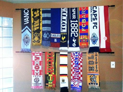 Soccer (football) sport scarf wall display diy with curtain rod Scarf On Wall Decor, Football Scarves Display, Sports Game Room Decor, Display Soccer Scarves, Rally Towel Display Ideas, Soccer Scarf Display Ideas, Football Scarf Display, Soccer Scarf Display, Diy Soccer Decor