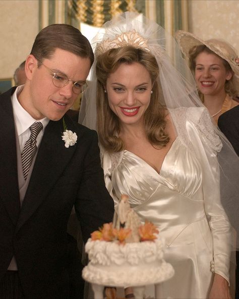 Costume designer Ann Roth dressed Angelina Jolie in an art deco-inspired wedding dress for her role as Margaret "Clover" Russell in the 2006 picture. The cream satin dress, vintage curls, and of course, bold lip, were all fitting for the film set in the 1930s. Cream Satin Dress, Movie Wedding Dresses, Movie Wedding, Wedding Dress Costume, Tv Weddings, Fairy Wedding Dress, Bridal Gowns Vintage, Iconic Weddings, Celebrity Wedding Dresses