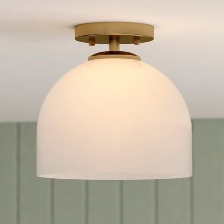 Illuminate your bedroom, bathroom, entryway, or hallway with the Shelby 1 Light Semi-Flush Mount. Its classic design and natural brass finish add a touch of timeless sophistication for both transitional and contemporary spaces. The elongated white dome-shaped glass shade emits a soft, diffused light, creating a warm and inviting atmosphere in any space. Size: 9.25-in W x 9-in H x 9.25-in D.  Color: Gold. Gold Ceiling Light Bedroom, Flush Mount Island Lighting, Brushed Nickel Semi Flush Mount, Long Hallway Lighting Ceilings, Bathroom Interior Lighting, Natural Flush Mount Light, Gold Hallway Lighting, Affordable Flush Mount Lighting, Bathroom Overhead Lighting