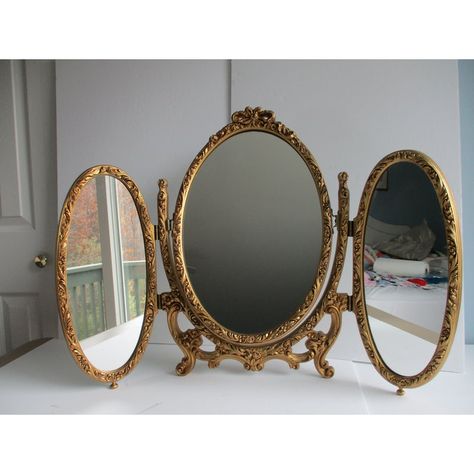 An Italian made, French Louis XVI style folding triptych table or vanity mirror.  This piece is made of metal and resin (plastic).  It features two folding oval side mirrors and a central mirror that can swivel upward or be completely removed from the mount; see pictures.  A fun and versatile mirror sure to please the eye.  This triptych mirror is in good vintage condition with some minor wear to the gilt paint on the body of the piece and a few minor specks on the mirrors themselves.  Please se Folding Mirror Vanity, Cool Vanity Mirror, Vintage Victorian Furniture, Vintage Room Accessories, 2 Vanities Side By Side, Vanity Mirror Vintage, French Chic Home Decor, Whimsigoth Furniture, Gold Room Aesthetic