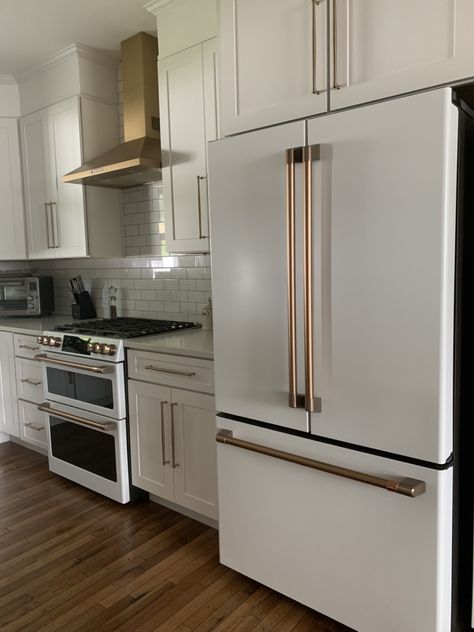 White Kitchen With White Cafe Appliances, Lg Cafe Appliances Kitchen, Fridge By Stove, Fridge Next To Stove Kitchen, Cafe Collection Appliances, Fridge And Stove On Same Wall, White And Gold Kitchen Appliances, Gold Appliances Kitchen, White Kitchen Appliances Ideas