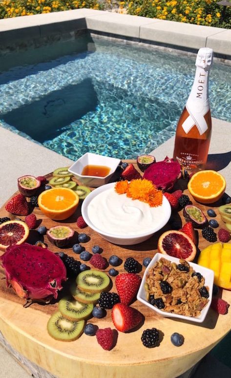 A large wooden board filled with sliced fruit, homemade vanilla yogurt, granola, and champagne sits next to a pool. Coachella Food, Poolside Brunch, Grad Brunch, Coachella Photos, Rosé Champagne, Brunch Board, Wishlist Board, Yogurt Granola, Best Brunch Recipes