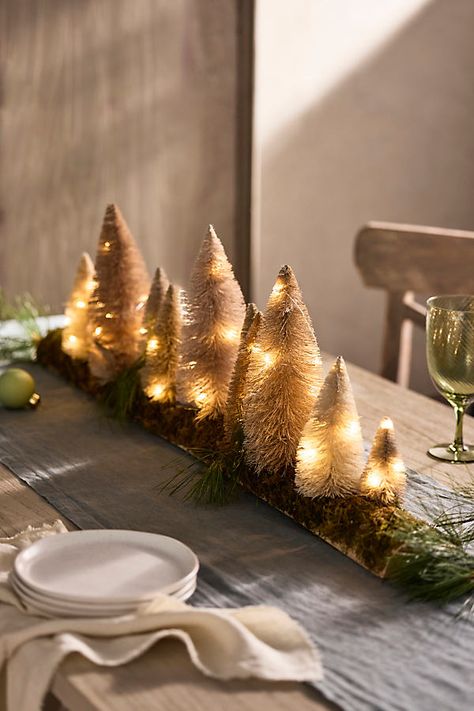 Dress your holiday table in an instant with this illuminated centerpiece, featuring a forest of neutral brush trees tucked into a dried moss base. | LED Mossy Brush Tree Centerpiece in Beige at Terrain Earthy Holiday Decor, Earth Toned Christmas Decor, Winter Forest Party Decor, Bottle Brush Trees Centerpiece, Holiday Centerpieces For Round Tables, Mix Christmas And Thanksgiving Decor, Winter Party Table Decor, Neutral Christmas Tablescapes, Thanksgiving Coffee Table Decor