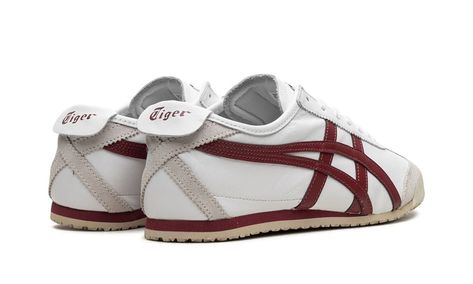 The Onitsuka Tiger Mexico ‘66 “White/Burgundy” is an eye-pleasing colorway of the retro sneaker by the Japanese footwear brand.  The Onitsuka Tiger Mexico ‘66 was originally a performance running shoe that debuted in 1966 during the trials for the Mexico City summer olympics in 1968, and through the years it has become a popular casual shoe.  The modern iteration of the model is largely similar to the original edition, but is made with contemporary materials and colors.  Here, “White/Burgundy” colorway has a white leather construction with burgundy tiger stripes on the sides.  “Onitsuka Tiger” branding is found on the tongue tag.  A vintage-inspired, thin cream foam midsole and rubber outsole complete the sleek design. Tiger Branding, Onitsuka Tiger White, Onitsuka Tiger Women Outfit, Japanese Sneakers, Onitsuka Tiger Women, Japanese Shoes, Luxury Paper Bag, Japanese Footwear, Contemporary Materials