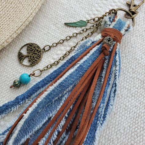 This is a totally handmade Boho tassel bag charm. This beautiful tassel is made with hand ripped denim fabric and faux leather lace decorated with a Tree of Life, Angel feather and Turquoise Howlite bead to add positive vibes to it. Unique With this beautiful tassel will add a Boho Bohemian touch wherever you hang it. Clip it on your purse, backpack, keychain or even in your rear view mirror. This is a handmade item made by order so the design may vary slightly. Handmade ripped denim Faux Leather Tree of life charm Turquoise Howlite bead Angel feather charm 1.5 inches lobster clasp Total lenght: 9 Inches Trendy Jewelry Ideas, Boho Tassel Keychain, Boho Bag Charm, Artisanats Denim, Purse Charms Diy, Glass Bead Crafts, Bohemian Crafts, Angel Feather, Leather Tassel Keychain