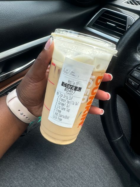 A hand holding a Dunkin’ cup with iced coffee flavored with French Vanilla and caramel, pictured inside a car Dunkin’ Donuts Drink, Dunkin Cold Brew Order, Coffe Drinks, Dunkin Donuts Coffee Drinks, Dunkin Donuts Iced Coffee Orders, Dunkin Drinks, Dunkin Iced Coffee, Dunkin Coffee, Coffee Orders