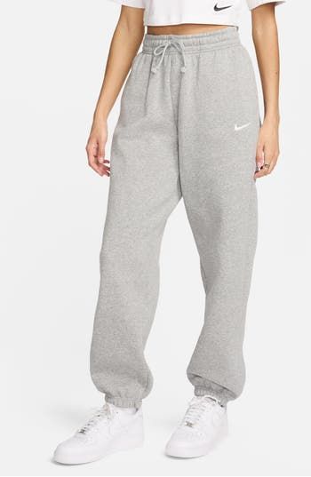 These midweight sweatpants are made of a brushed cotton-blend fleece to keep you feeling cozy no matter where the day takes you. 29 1/2" inseam; 11" leg opening; 12" front rise; 16 1/2" back rise (size Medium) Elastic/drawstring waist Side-seam pockets 80% cotton, 20% polyester Machine wash, tumble dry Imported Grey Nike Sweatpants Outfits, Nike Grey Sweatpants, Grey Nike Joggers, Grey Nike Sweatpants, Nike Sportswear Phoenix Fleece, Sweatpants Nike, Oversized Joggers, Oversized Sweatpants, Cute Sweatpants