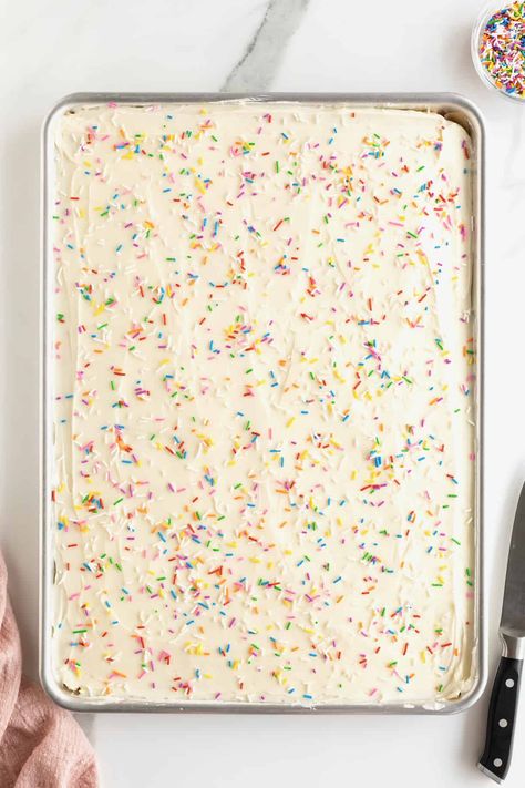 A sheet pan of cookies covered with white frosting and rainbow sprinkles. Bar Cookies Recipes For A Crowd Sheet Pan, Bar Cookie Recipes For A Crowd Sheet Pan, Half Sheet Pan Cookie Bars, Pan Sugar Cookie Recipe, Sheet Pan Bar Recipes, Sheet Pan Cake Mix Cookie Bars, Big Batch Bars Sheet Pan, Sheet Pan Sugar Cookies, Sheet Pan Cookies For A Crowd