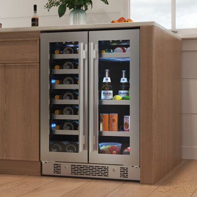 The Black Stainless Steel finish does NOT include the door locks. Features: 21 bottle capacity and 64 can capacity Standard 24-inch width for typical undercounter installations Versatile design allows for built-in or freestanding installation Easily monitor and change the temperature with the sleek touch control panel Selectable blue, white or new, amber color interior LED lighting options Low-E, argon filled gas, double paned glass, provides exceptional insulation and protection to ensure your collection is preserved Rest easy with the security of the True Key door lock (Stainless Steel only) A wide thermostat range of 40-65 degrees F allows you to dial in the perfect temperature Nine roll-out wood shelves with stainless steel trim French door design Specifications: Can Capacity: 86 Bottl Beverage Fridge, Beverage Center, Beverage Refrigerator, Lighting Options, Beverage Cooler, Movie Room, Wine Storage, Touch Control, Black Stainless Steel