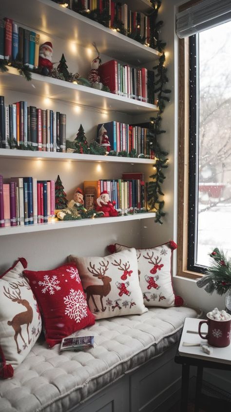 Transform your reading space into a winter wonderland with vibrant books, Christmas ornaments, and soft cushions. This cozy nook features a plush bench with holiday-themed pillows and a window view of light snowfall, perfect for the holiday season. Add hot cocoa and a twinkling garland to complete the look! #HomeLibraryIdeas #CozyNook #WinterReading #ChristmasLibrary Book Case Christmas Decorating, Top Of Bookshelf Christmas Decor, Christmas Decorated Bookshelves, Christmas Library Aesthetic, Books And Christmas Aesthetic, Christmas Book Shelves, Christmas Reading Nook, Book Shelf Christmas Decor, Christmas Aesthetic Books