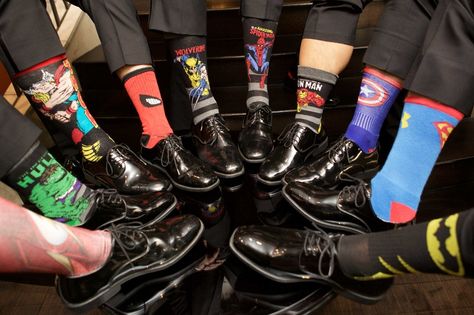 Groomsmen in dress shoes and slacks with superhero theme socks hulk spiderman superman batman more Groomsmen Marvel Socks, Super Hero Wedding Theme, Avengers Wedding Theme, Marvel Wedding Decorations, Avengers Themed Wedding, Wedding Marvel Theme, Groomsmen Socks Ideas, Spiderman Wedding Theme, Superhero Wedding Ideas