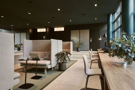 In this work area within a hotel, comfortable booths are paired with small laptop tables, while beside the windows, there's a long wood table. #HotelDesign #Workspace Coworking Space Design, Industrial Office Design, Corporate Office Design, Office Space Design, Office Lounge, 카페 인테리어 디자인, Best Office, Bureau Design, Workplace Design