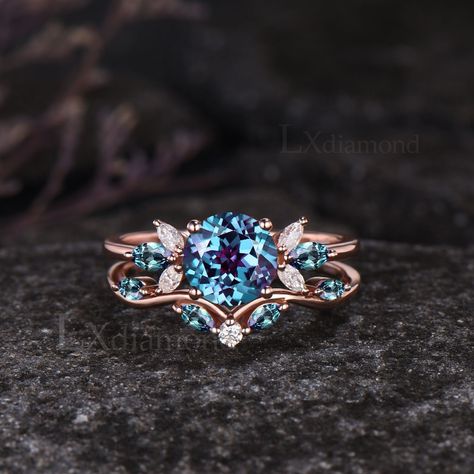 Item description ✦ Handmade, high-quality item! ✦ Material: 925 sterling silver, Solid 10k/14K/18K GOLD (can be made in white/rose/yellow gold) Engagement ring ✦ Center stone: Lab Alexandrite. ✦ Size/Weight: 7mm Round Cut ✦ Side stones: Marquise Cut Lab Alexandrites and Moissanites. Wedding bands ✦ Gemstones: Marquise Cut Lab Alexandrites and Round Cut Moissanites. Any ring size can be made,if the ring size is not in the option list ,contact me. As it is handmade,it needs 3-4 weeks to finish and then be shipped by usps or DHL. Return policy: We offer 30 days return policy. For any reason, if you are not completely satisfied with your order, you may return it for a refund.  Buyer is responsible for the handcraft fee (15%-30% of the total price) and the return shipping cost. Alexandrite And Moonstone Ring, Engagement Rings Alexandrite, Blue Stone Engagement Ring, Engagement Rings Women, Alexandrite Rings, Alexandrite Wedding Ring, Marquise Engagement Ring, Delicate Engagement Ring, Pretty Engagement Rings