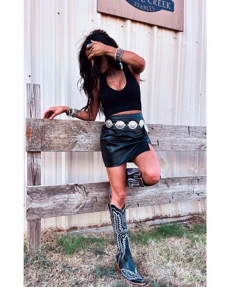 Nashville Black Skirt Outfit, Black Leather Skirt And Cowboy Boots, Black Leather Skirt Outfit Western, Black Skirt Nashville Outfit, Country Concert Black Boots, Leather Skirt With Cowgirl Boots, Black Denim Country Outfit, Country Leather Skirt Outfit, Black Leather Shorts Concert Outfit