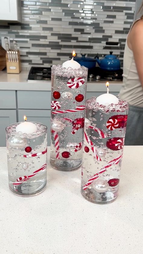 Easy holiday decoration | candy cane, pearl, candy | Easy holiday decoration I make a floating candle holiday decoration with candy canes and pearls. | By Justine Kameron Justine Kameron, Easy Holiday Decorations, Candy Cane Candle, Canes Decor, Candy Cane Decorations, Floating Candle Centerpieces, Christmas Vases, Floating Candle, Christmas Wreaths Diy Easy