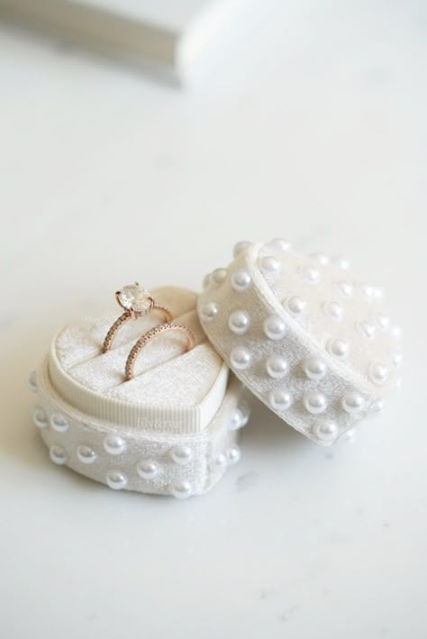 "This vintage-inspired velvet ring box will complement your wedding day theme and add a luxurious touch to your wedding day photos . An optional pearl accent offers a delicate finishing touch and you get the choice to add an extra slot for your wedding ring.  Every bride deserves to shine on their special day, why not add a special gift?  Ring Box Details: . Handmade assortment of 6mm faux pearls all over, adding an elegant touch . Made from high quality velvet  . Measures 2\" x 2\" . Please lea Cute Engagement Ring Boxes, Engagement Ring Case, Pearls In Wedding Decor, Pearl Wedding Reception, Gold And Pearl Wedding Decor, Pearl Wedding Inspiration, Ring Boxes For Wedding, Green And Pearl Wedding, Pearl Wedding Theme Decor