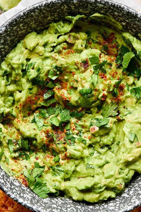 Inspired by my restaurant days, this easy Fresh Guacamole recipe combines not 1 but 2 ripe avocados with jalapeños, red onion, fresh lime juice, and lots of cilantro. Smashed together in a zip-top bag (or molcajete!) with my secret ingredient –Tajín! – the result is a chunky-creamy guacamole dip with bright, tangy, and spicy flavor. Ready in 15 minutes or less and with all the citrus, this homemade guacamole never browns! #guacamole #guacamolerecipe #guacamoledip #avocadorecipes #mexicanfood Guacamole Recipe No Cilantro, Fresh Guacamole Recipe, Mexican Guacamole Recipe, Guacamole Dip Recipes, Creamy Guacamole, Mexican Guacamole, Homemade Guacamole Recipe, Guacamole Ingredients, Spicy Guacamole