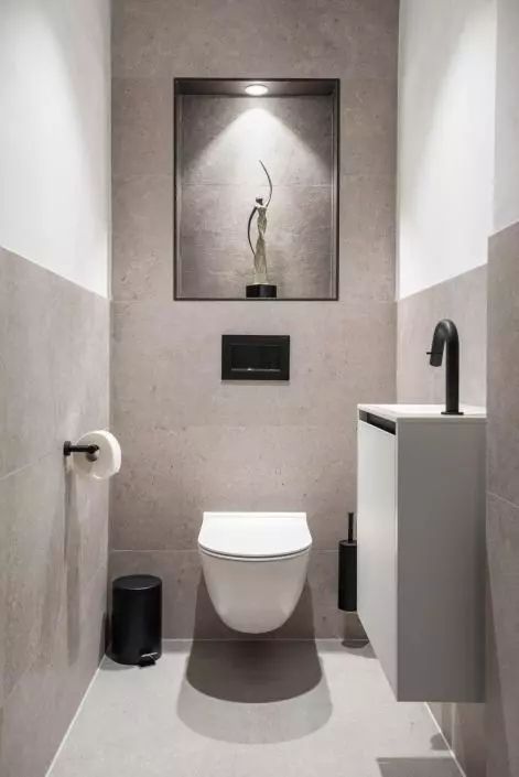 a neutral contemporary powder room clad with large scale greige tiles, with a floating vanity and black touches Small Toilet Design Modern, Small Toilet Room Decor, Small Wc Ideas, Modern Toilet Room, Small Toilet Ideas, Small Wc, Toilet Inspiration, Wc Inspiration, Modern Toilets