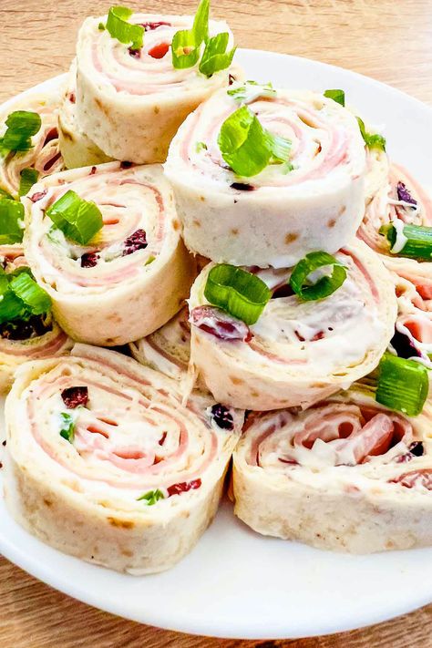 Learn how to make delicious Ham and Cheese Tortilla Roll Ups with this easy recipe. Perfect for parties and snacks, these pinwheels are a hit with everyone. Meat And Cheese Tortilla Roll Ups, Ham Tortilla Roll Ups, Chicken Pinwheels Appetizers, Tortillas Roll Ups, Tortilla Roll Ups Cream Cheese, Tortilla Roll Up Recipes, Roll Ups Tortilla Pinwheels, Tortilla Roll Ups Appetizers, Ham And Cheese Tortilla